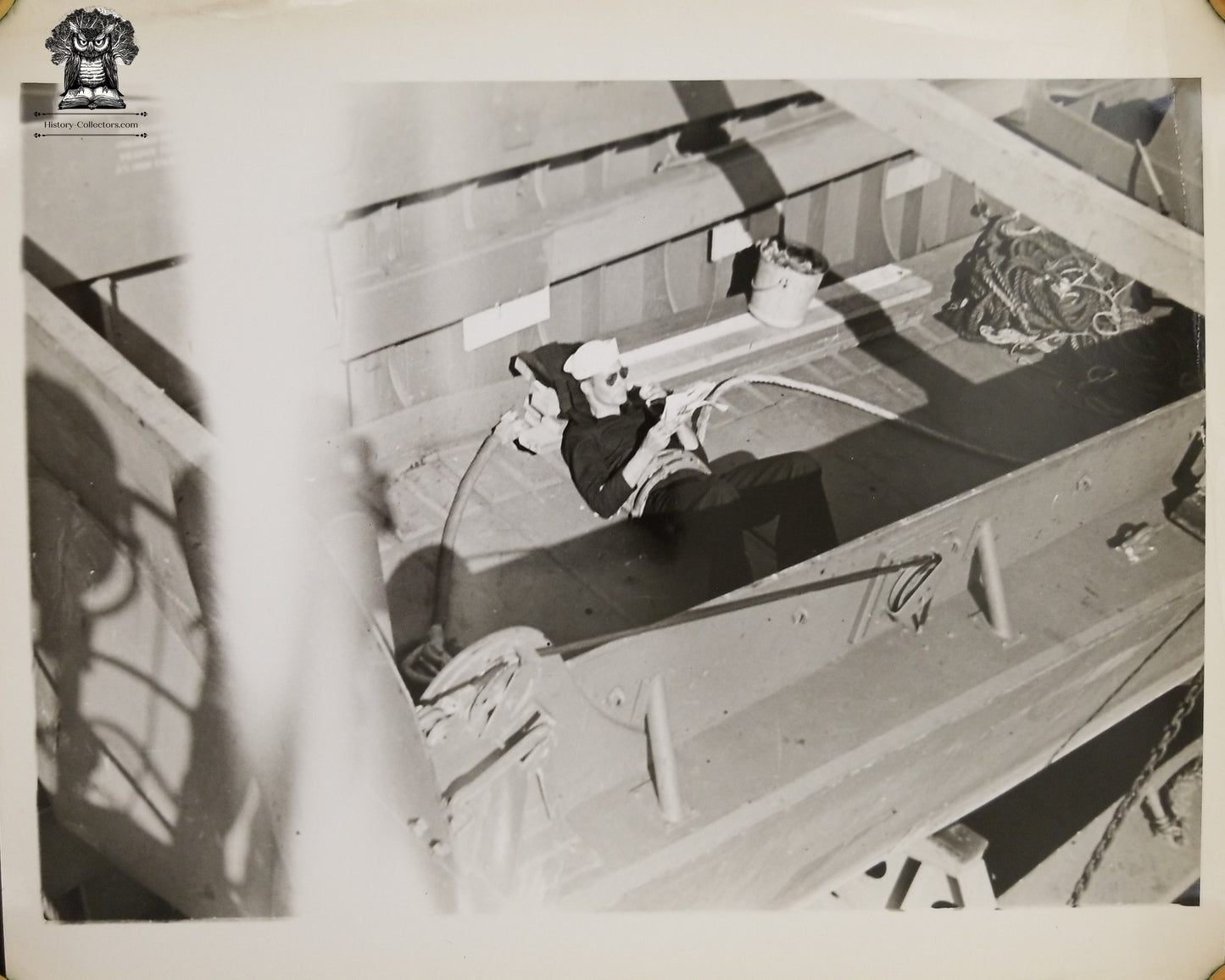 c1940s WWII Era United States Navy USN Sailor Reading Relaxing Taking A Break Inside LCVP Higgins Landing Boat Craft Photograph